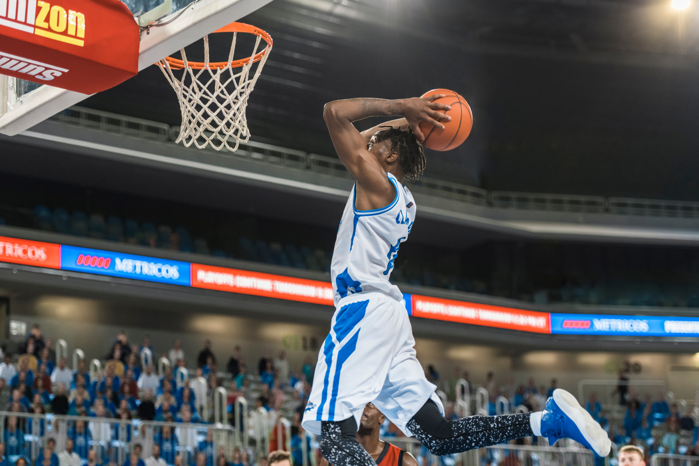 Basketball player scoring slam dunk